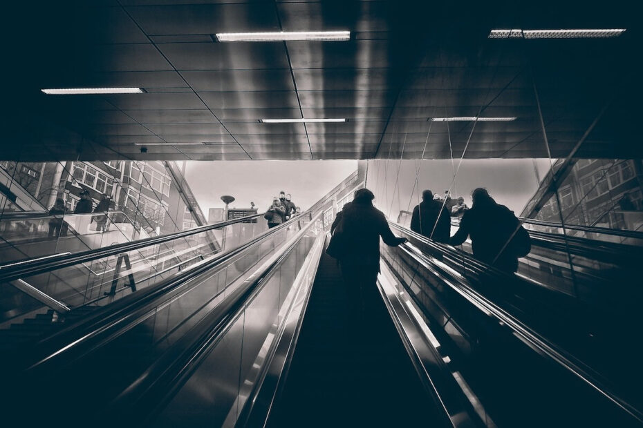 black and white photograph of escalators in city metro